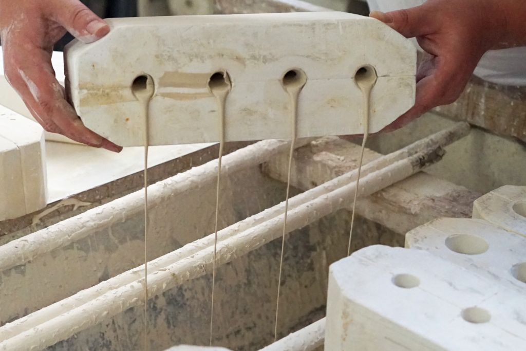 Excess mass poured into a casting bench