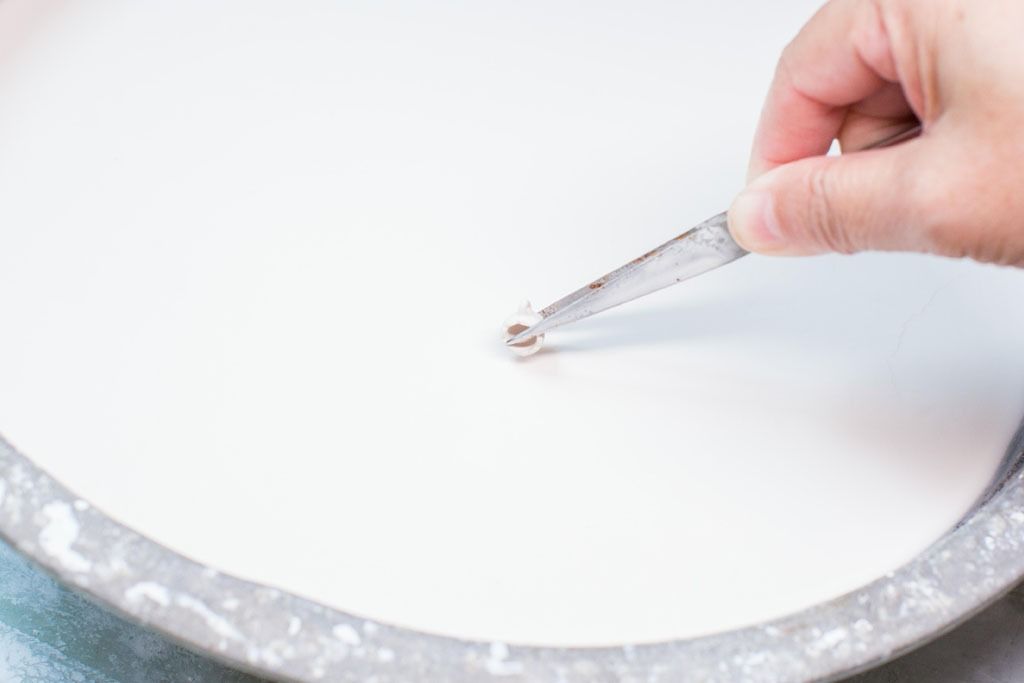 Small parts are dipped into the glazing compound with tweezers