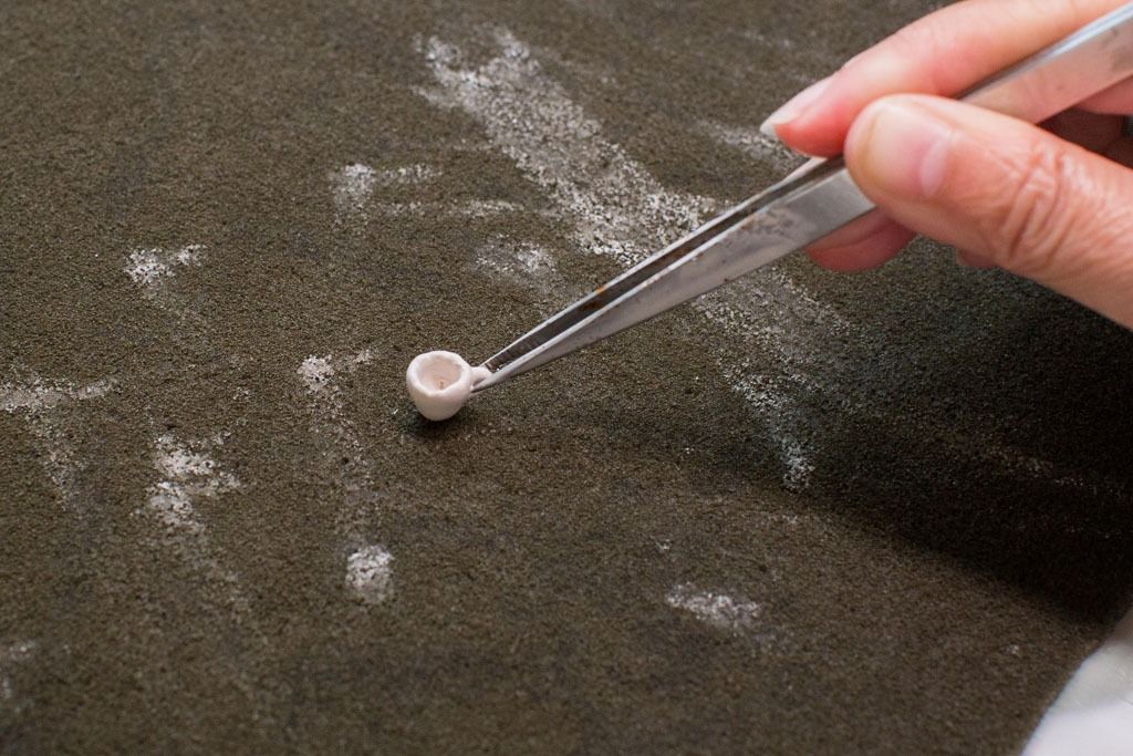 Rub off glaze from all bottoms and stand parts